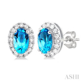 5x3 MM Oval Shape Blue Topaz and 1/8 Ctw Round Cut Diamond Halo Semi-Precious Stud Earrings in 14K White Gold